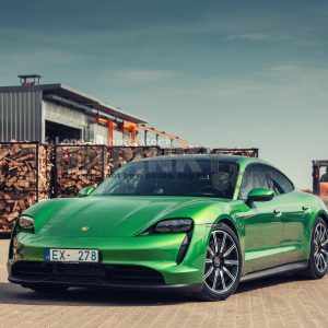 Porsche Taycan Turbo S Electric EV green clear car auto mobile wood factory backyard parked parking lot clean plugin supercar power shinny day summer hot rental