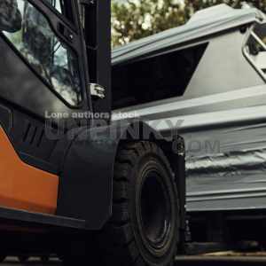 A forklift lifts a motor yacht