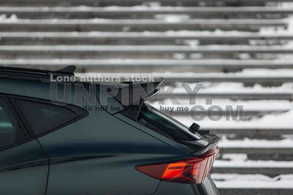 Modern SUV rear trunk with carbon spoiler and taillight