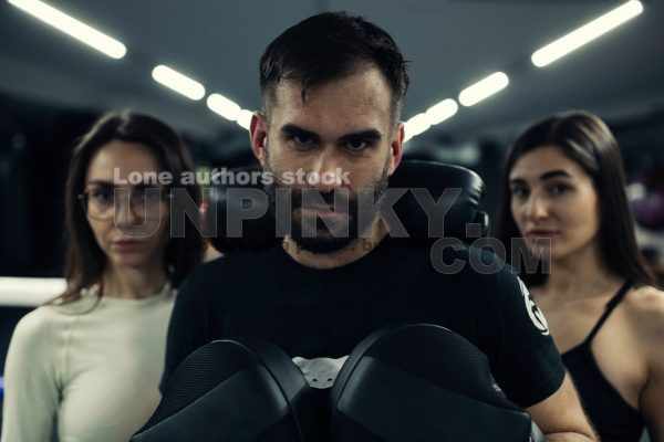 Boxing trainer in the gym with girls before training