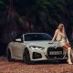 Woman near BMW 430I convertible between palms | Editorial