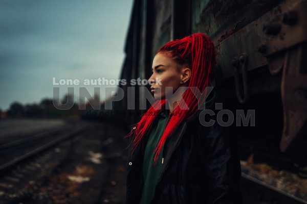 Portrait of young woman outside with red hairs