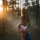 Beautiful naked woman with tattoo stay at the morning forest with a fog