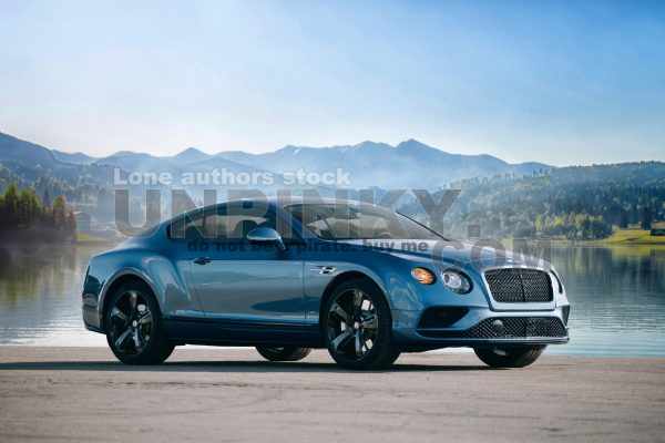Bentley Continental GT supercar near lake and mountain background
