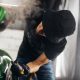 A man makes a detailing of a new car and use a steam to wrap a mirror