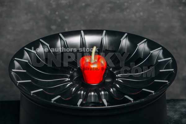 Car rims with red pepper close up