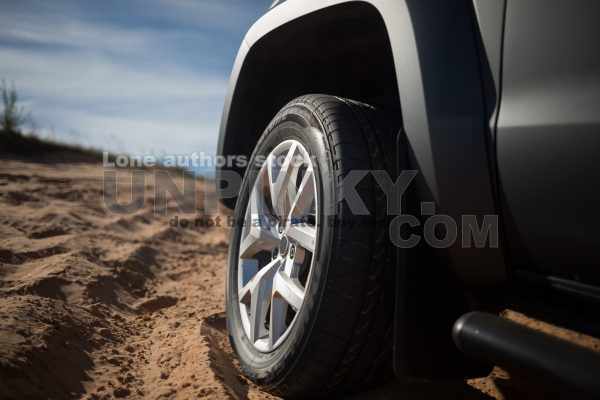 Modern pickup truck car front side wheel at the middle of desert. Car at the off-road