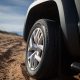 Modern pickup truck car front side wheel at the middle of desert. Car at the off-road