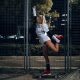 Girl stay at skateboard at night in the spotlights