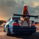 Sexy woman is sitting at the trunk of tuning car