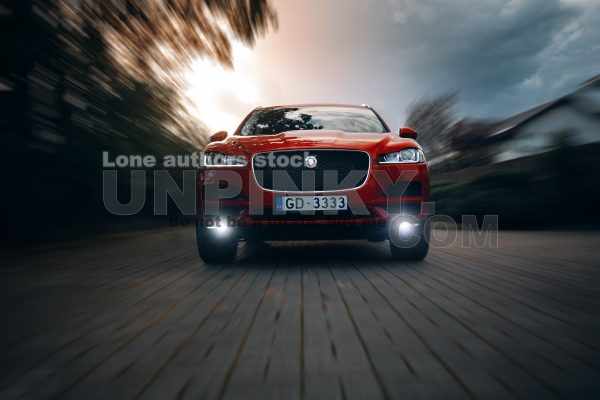 Jaguar F-Pace in the motion at the city street. Luxury car go fast
