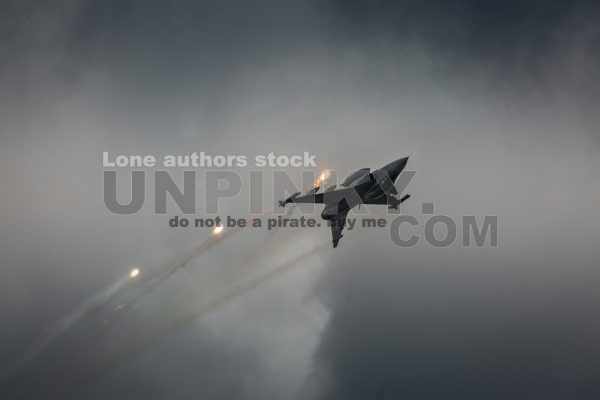 Modern jet fighters shooting fire flares rockets with sparks. Airplane deploying . fire protection IRCM