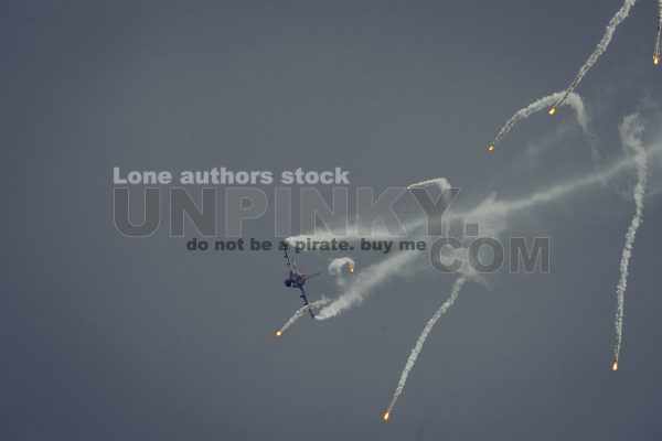 Modern jet fighters shooting fire flares rockets with sparks. Airplane deploying . fire protection IRCM