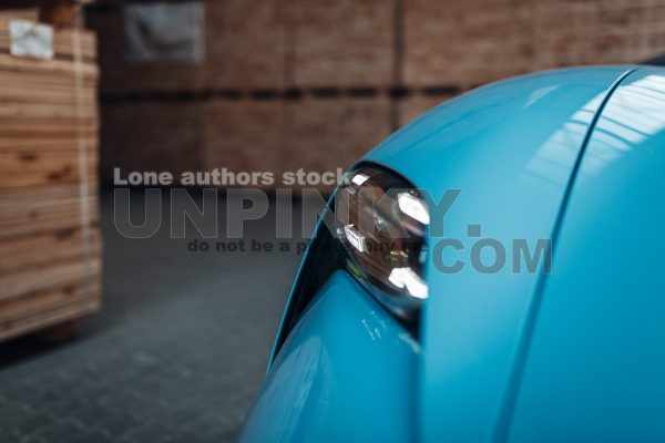 Headlight of modern luxury supercar. Close up detail shot