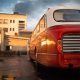 Classic red bus at the central station station at the early morning after rain