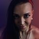 Portrait of an attractive woman at the darkroom with backlight