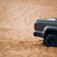 Modern pickup truck car rear side at the middle of desert. Car at the off-road