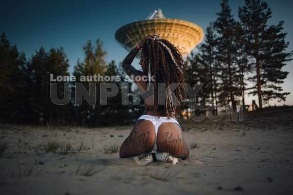 Sexy tattooed woman near satellite dish antenna