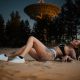 Sexy tattooed woman near satellite dish antenna
