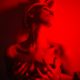 Sexy undressed girl at the dark room with red light