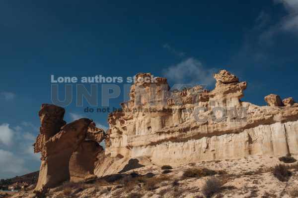 Beautiful and unusual rock on the shore of the bay