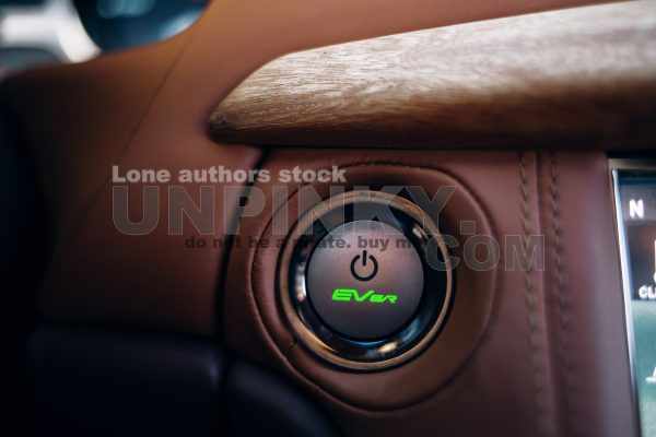 Start and stop engine button in sports car. Car ignition system at the panel