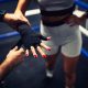 Trainer help to tape woman hand with a sport belt before kickbox