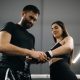 Trainer help to tape woman hand with a sport belt before kickboxing
