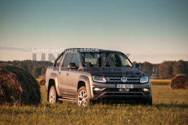 Volkswagen Amarok V6 in valley near a stack of hay