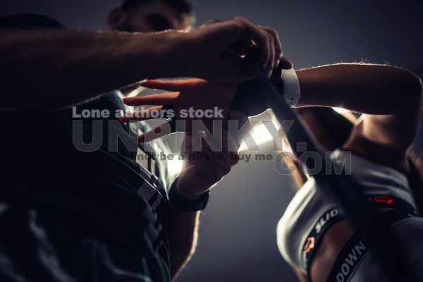 Trainer help to tape woman hand with a sport belt before kickboxing