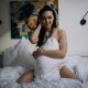 Attractive woman wake up in the morning in the modern bright hotel room. Naked neck of beautiful lady at the morning