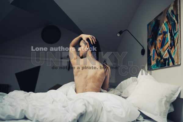 Attractive women wake up in the morning in the modern bright hotel room. Naked neck of beautiful lady at the morning
