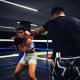 A girl in boxing training at the ring with a trainer