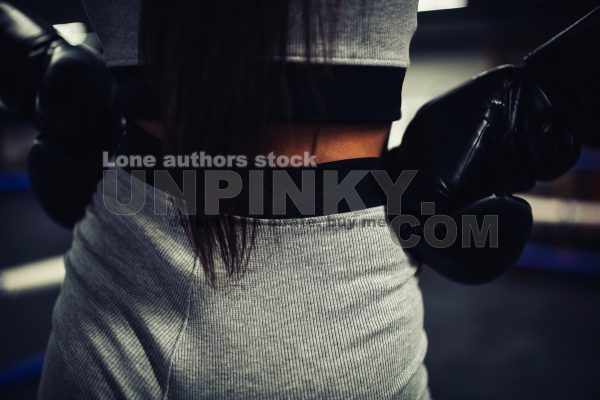 Girl in sports top and shorts before boxing training close up