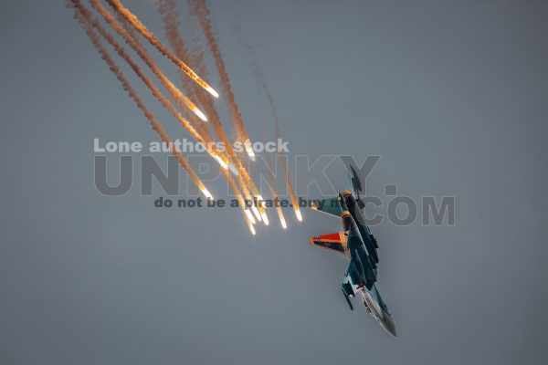 Modern jet fighters shoot fire flares rockets with sparks. Airplane deploying . fire protection IRCM