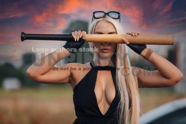 Attractive girl with a baseball bat on the street covering her eyes