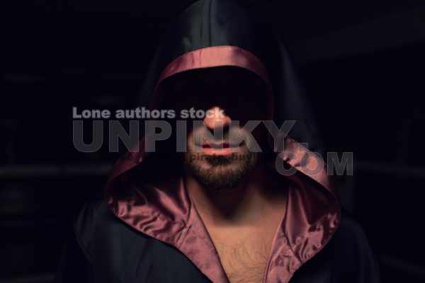 Focused and Determined: A Boxer's Journey to Glory as They Train in a Hoodie at the Gym
