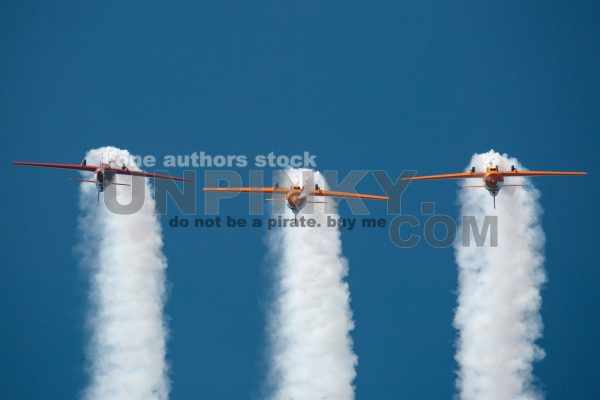 Aerobatic team performing a loop at small planes