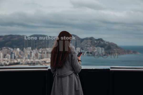 Woman enjoy the view from the top of skyscraper