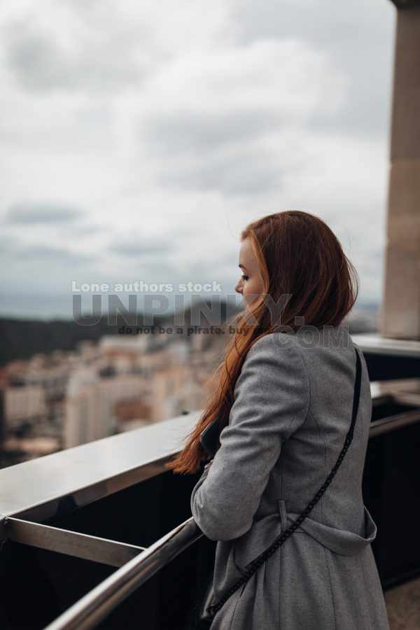 Woman enjoy the view from the top of skyscraper
