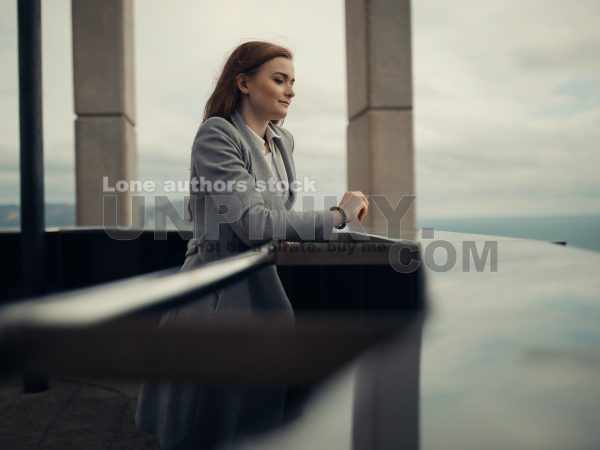 Woman enjoy the view from the top of skyscraper