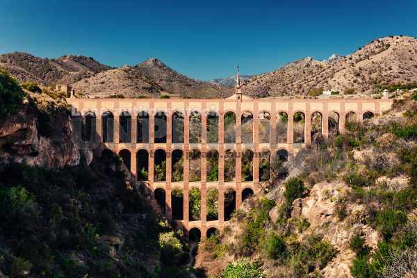 Old aqueduct arch over a dried up river near the Spanish city of Nerja