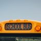 School bus kids – educational transport sitting in the parking lot waiting to be in service